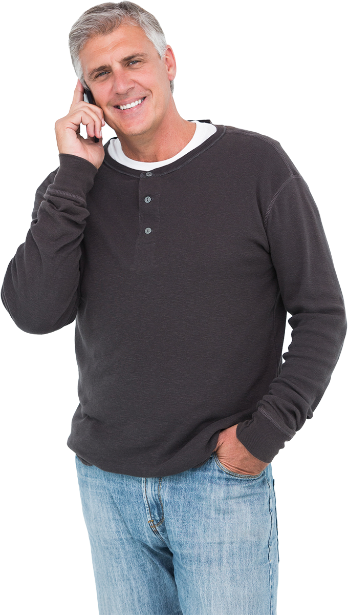 Image of a male person talking on the phone wearing a dark gray shirt and blue jeans