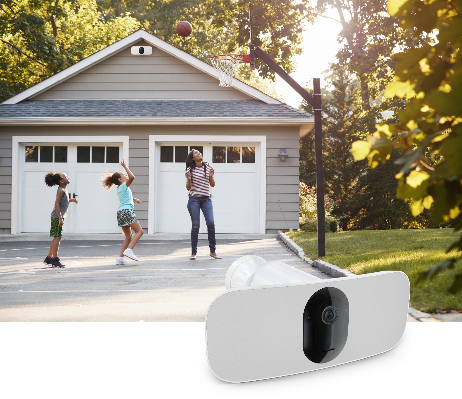 Three kids playing basketball outside a home secured with Arlo Security Camera